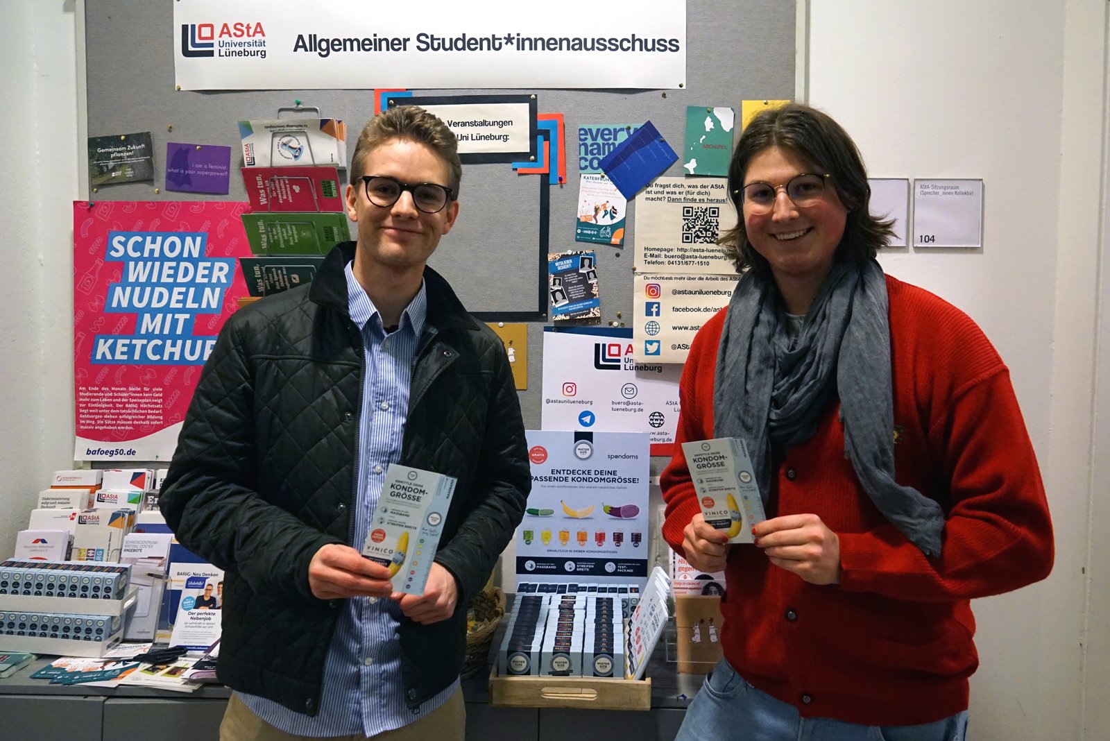 Luis zo spoločnosti Spondoms (vľavo) otvára bezplatný dávkovač kondómov spolu s Maxom z AStA Univerzity Leuphana v Lüneburgu (vpravo).